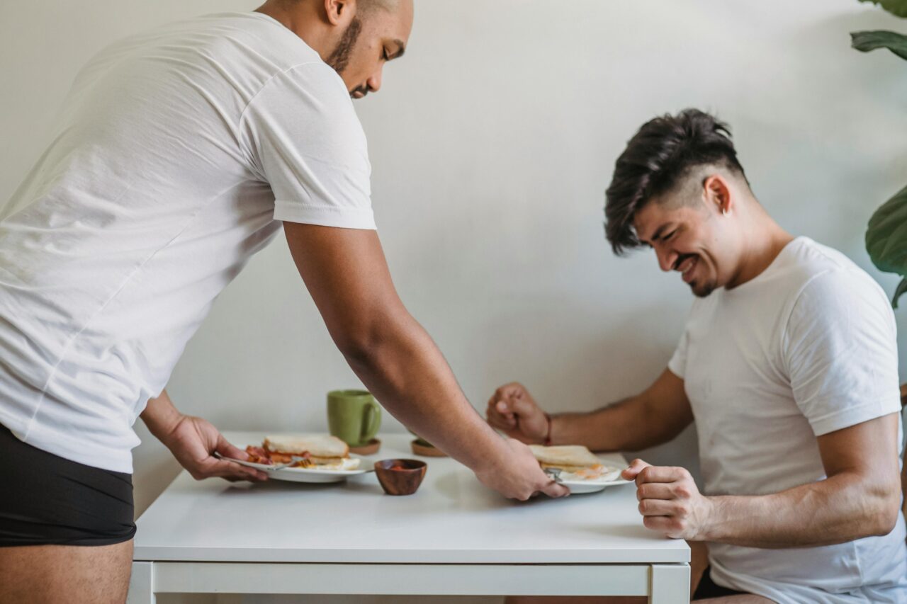 A joyful couple shares a relaxed breakfast at home, showcasing love and companionship.